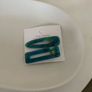 Two-piece set of retro marble acetate hair clips in teal blue with gold metal clips