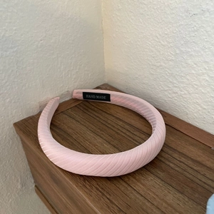 Minimalist pink striped fabric padded headband featuring a handmade black interior label