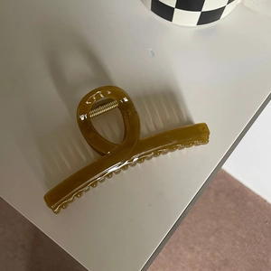 Large amber brown jelly hair claw clip with a glossy finish and minimalist Korean design