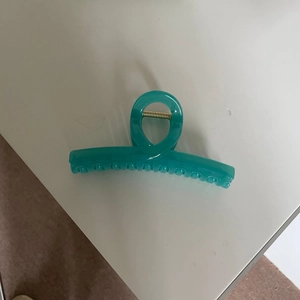 Jelly teal blue hair claw clip with cross design and golden spring for casual styling