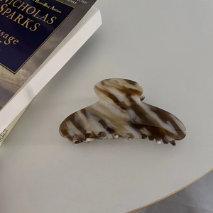 French tortoiseshell acetate hair claw clip with golden handmade logo on marble finish