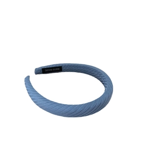 Light blue wide padded headband with striped texture and handmade woven label detail