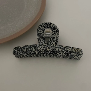 French style large acetate hair claw with chic black and white terrazzo pattern