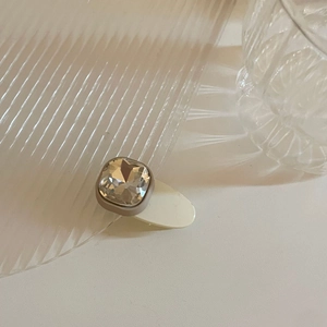 Minimalist square crystal hair clip with a beige matte base and clear gemstone