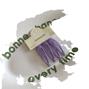 Set of three purple matte finish snap hair clips on a white display card for girls