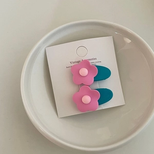 Set of two cute pink flower hair clips with green duckbill clips on display card