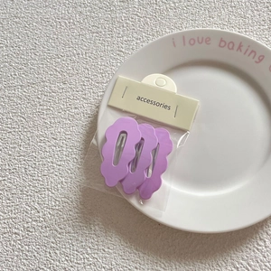 Set of 3 taro purple wavy hair clips on a ceramic plate with card packaging