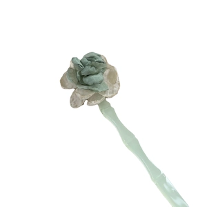 Elegant jade-green bamboo style hair pin with soft fabric floral accents for women