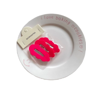 Set of 3 rose pink wave shaped metal hair clips on a cute decorative dessert plate