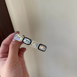 Rectangular hair clip with sparkling colorful crystals and a black and white frame