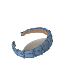 Blue quilted velvet sponge headband with textured fringe detail and non-slip lining