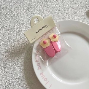 Set of two sweet pink floral hair clips with small yellow flowers and dot details