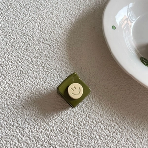 Korean style olive green square hair claw clip with a white smiley face on white background