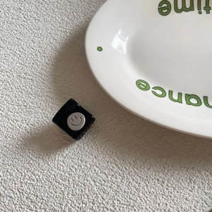Korean style small square black hair claw clip with a grey smiley face icon design