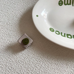 Grey-purple square hair claw clip with green smiley face, matte resin finish for women