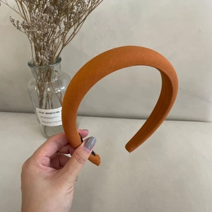 Close-up of thick orange sponge headband showing the textured fabric and premium quality