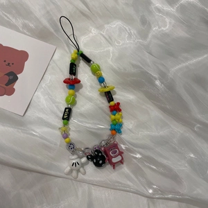 Close-up of colorful beaded phone strap with strawberry bear and mouse shape charms