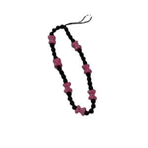 Handmade beaded phone strap with black glossy beads and pink resin bow charm decor