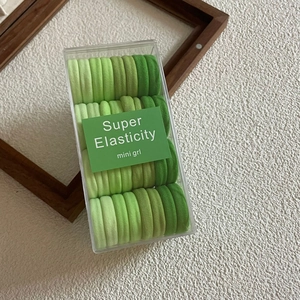 Set of green candy-colored high elasticity hair ties in a clear minimalist box