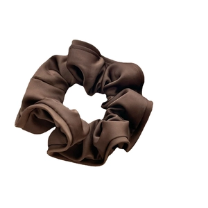 Satin fabric scrunchie in coffee brown with ruffled edges for elegant hairstyling