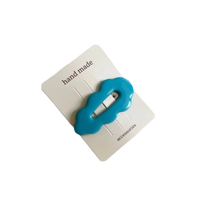 Cute blue wavy acetate BB hair clip for women on a white display card minimalist style