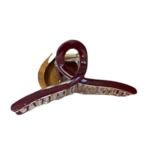 Elegant deep red cross hair claw clip with glossy ribbon design and metallic spring