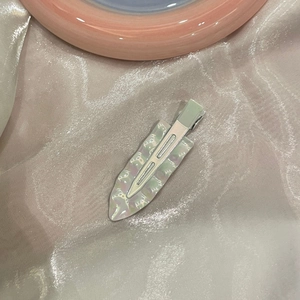 Makro-Detail der schillernden Meerjungfrau-Haarklammer mit silbernem Metallclip-Verschluss