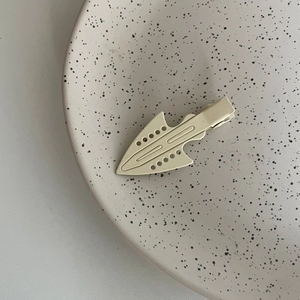 Minimalist matte cream hair clip with geometric cutout design and alligator clip base