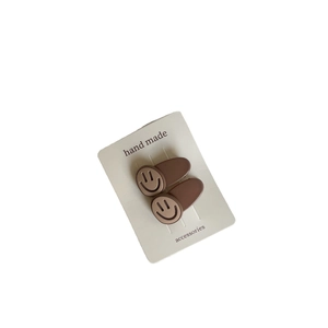 Set of two cute matte brown bear smile hair clips on elegant display card