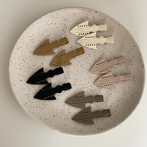 Minimalist matte arrow hair clips set in neutral earth tones for makeup and styling