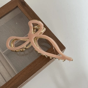 Elegant peach pink bow hair claw clip with golden metal frame for women hair styling
