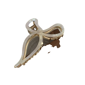 Elegant gold metal bow hair claw with white pearlescent acetate finish for women