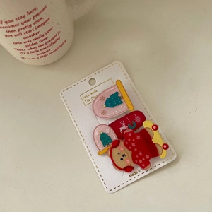 Three-piece Christmas hair clip set featuring reindeer and bear designs on a card