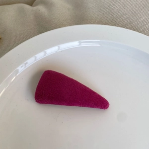 Fuchsia flocked triangular BB hair clip on a white plate with minimalist style