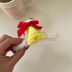 Christmas plush hair claw with red ribbon bow and yellow embroidered bell design