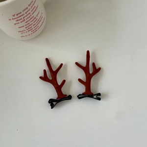 Detailed view of plush reindeer antler hair clips in deep brown on black alligator clips