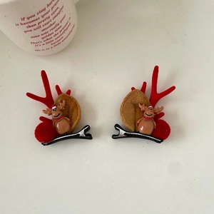 Pair of festive Christmas reindeer antler hair clips with plush ears and small deer charms