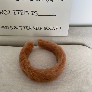 Close-up of soft khaki brown faux fur headband showing its fluffy texture and thickness