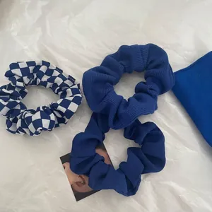 Klein blue scrunchie set including checkered, knitted, and crepe fabrics for hair styling
