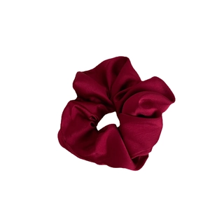 Elegant wine red satin scrunchie with silky luster for festive hairstyling