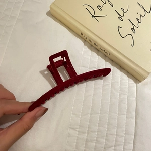 Detail showing the size and velvety texture of a deep red flocked hair claw clip