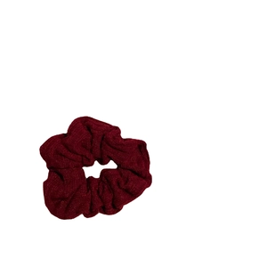 Deep red oversized scrunchie in soft knit texture for elegant New Year hair styling