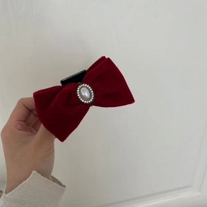 Elegant red velvet bow hair clip with central pearl and rhinestone accents for women