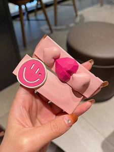 Détails rapprochés de barrettes en cuir rose avec motifs de smiley et de cœurs