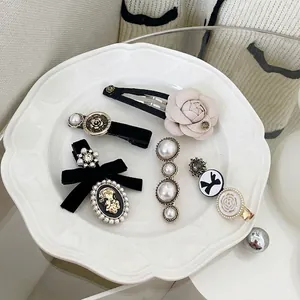Vintage French style hair clip set with pearls and velvet bows in white porcelain tray