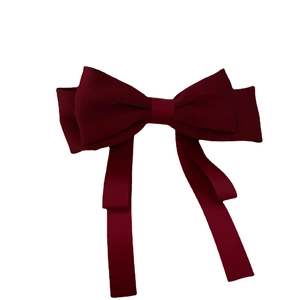 Elegant dark red satin bow hair clip with long ribbons on a white background
