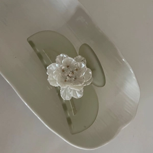 Elegant translucent green hair claw clip with a 3D white floral design and pearl finish