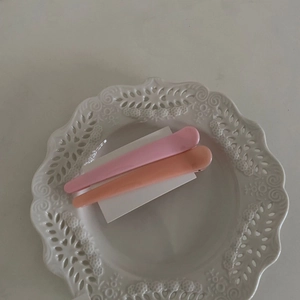 Set aus zwei farbenfrohen Macaron-Entenschnabel-Haarspangen in Rosa und Orange