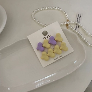 8-piece heart macaron hair clip set in purple and yellow on a handmade card