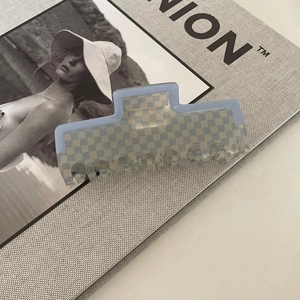 French blue checkerboard acetate hair claw clip on fashion magazine background
